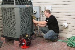 HVAC technician repairing an air conditioning